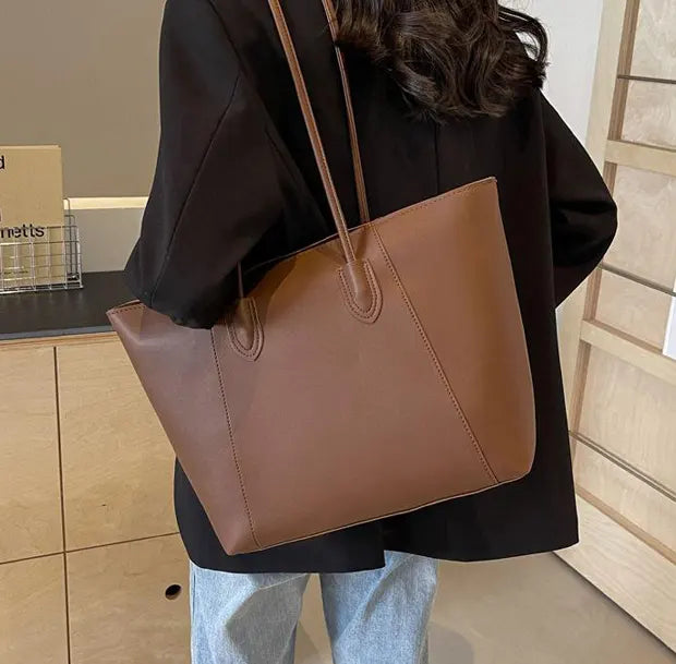 シックコンビネーショントートバッグを着用する女性
