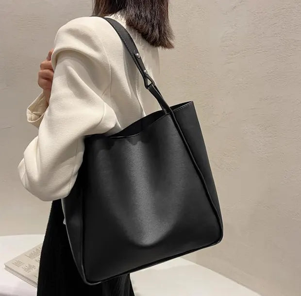 リュクスバケツトートバッグのブラックを着用する女性
